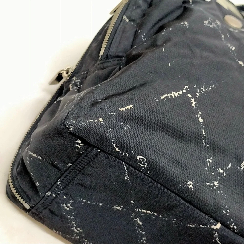 CHANEL Cream and Black Travel Bag with Elegant Design